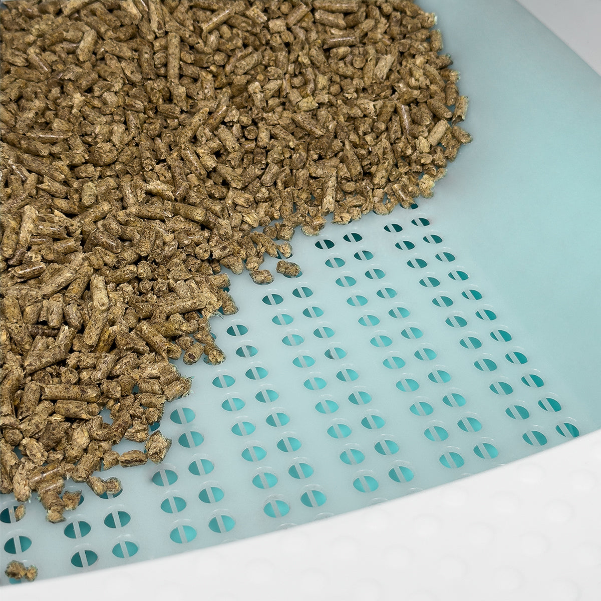 Pine Pellet Litter Box - Close up with pine pellets on one side of the litter box - Turquoise